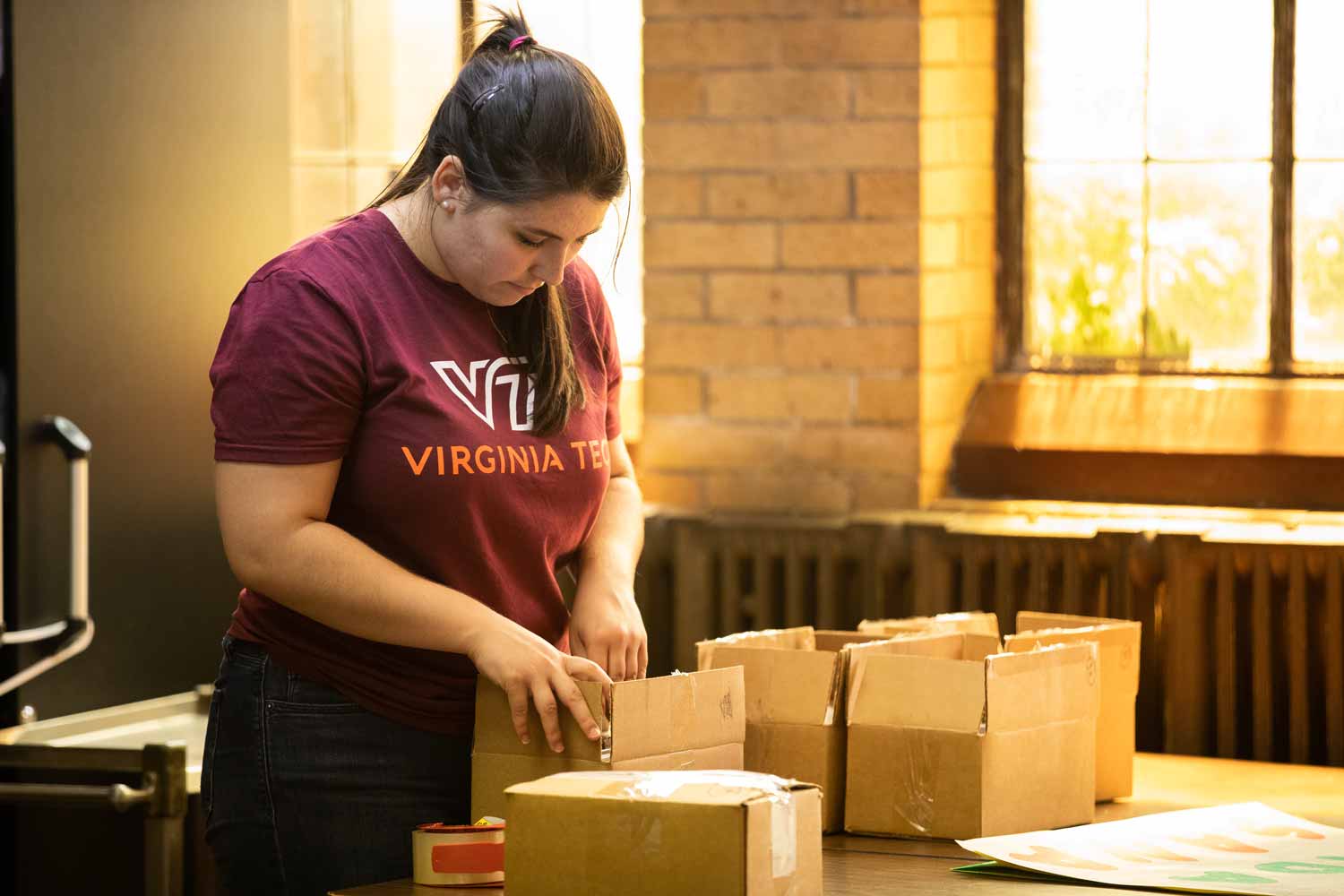 A Virginia Tech grad student prepares water sample kits in the basement of a church.