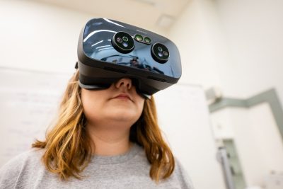 A student wearing VR goggles.