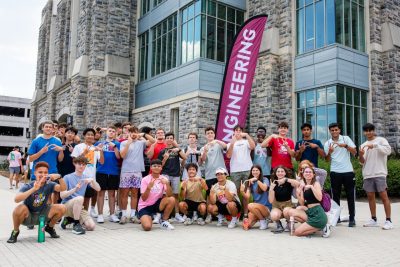 A group of engineering students stands in from of Goodwin Hall for a group photo.