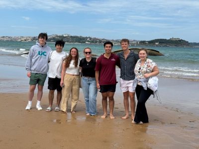 A group of students on the beach in the day.