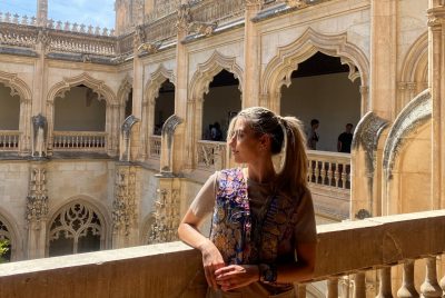 Romina standing on a balcony of a historical building