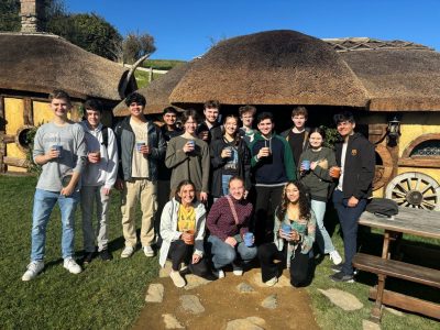 A group of students standing in front of cottages