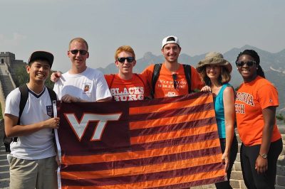 students with Virginia Tech flag. Giving page.