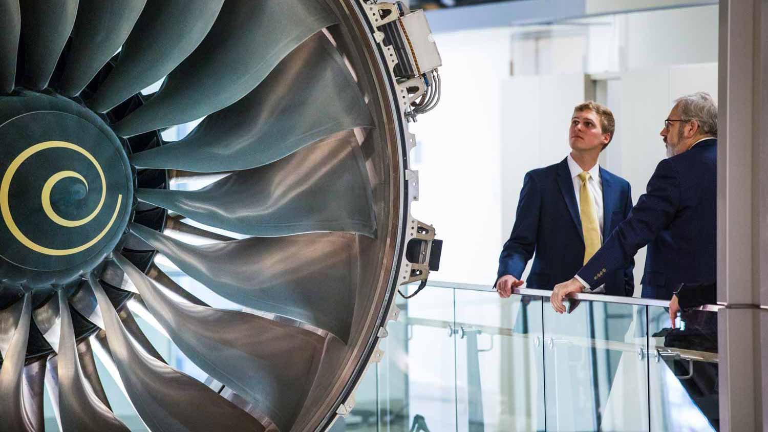 rolls-royce-partnership A Virginia Tech student admires a Rolls-Royce engine with a Rolls Royce executive
