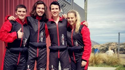 Four students in red jumpsuits in New Zealand.
