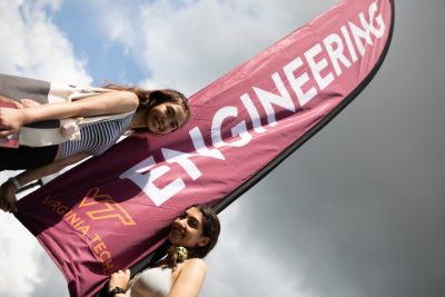 Two new students next to an Engineering banner.