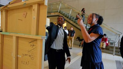 students pointing at project