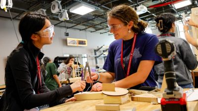 2 girls working in maker space