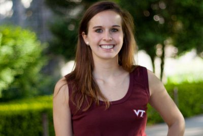 Female student posing outside with a maroon VT shirt on.