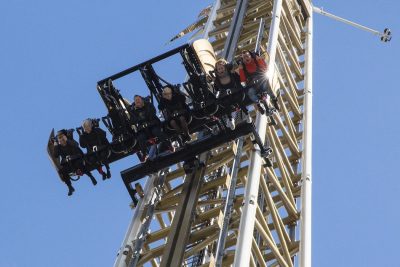 People on a roller coaster going straight down