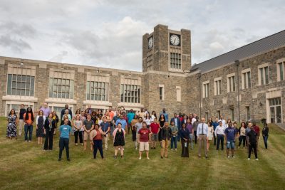 Group of graduate students and virginia tech faculty outside behind the Inn at Virginia Tech