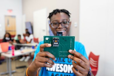 boy showing electronics project