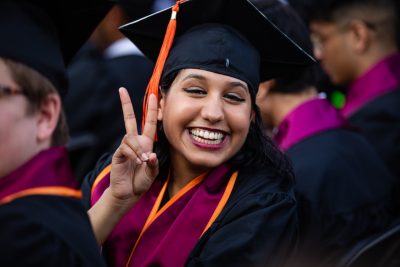 Graduate giving the peace sign