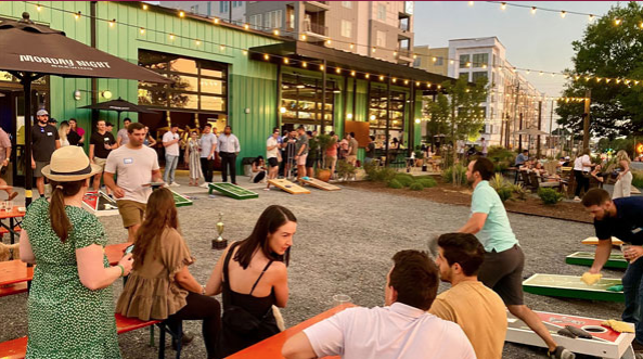 People playing cornhole at a brewery