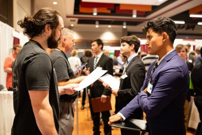 Student talks with a potential employer at a career fair