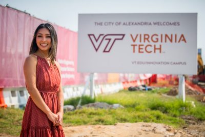 Grad student poses in front of Innovation Campus sign