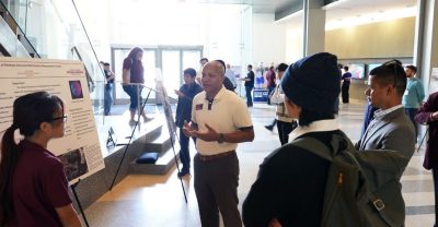 Irvine Sloan (at center) speaks to students at the Mechanical Engineering Fall Undergraduate Expo