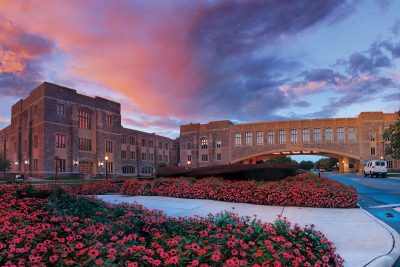 Torgersen Hall at sunset with pink flowers infront