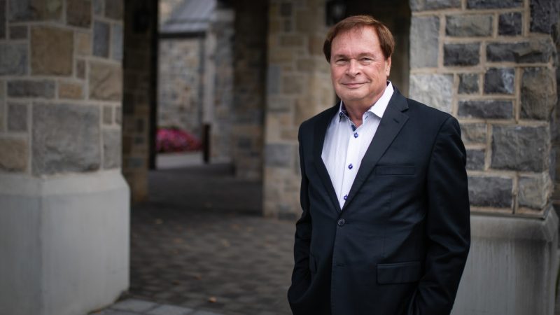 Brian Nerney posing outside of the Inn at Virginia Tech.