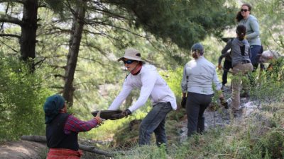 A line of students help in a chain move water in Nepal..