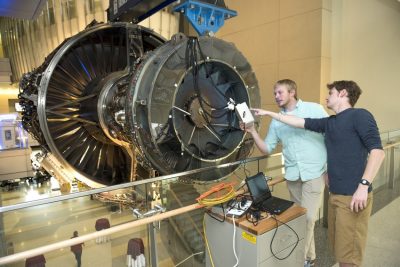 Students from Dr. Al Wicks' Mechatronics lab have developed an electrical system that will blow air into the blades of the Rolls Royce Trent 1000 Engine in Goodwin Hall and make it turn. 