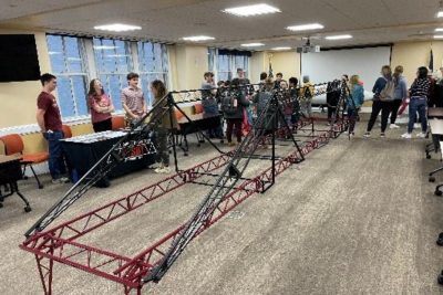 The Steel Bridge Team displaying their bridge at a conference.