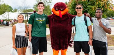 New students standing with the HokieBird.