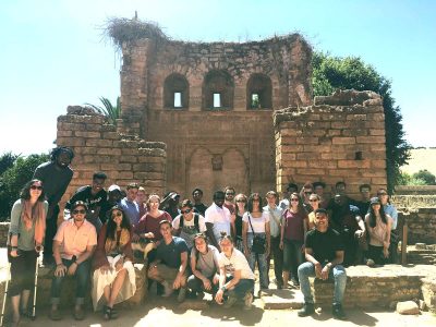 32 engineering students at stone building in Morocco.
