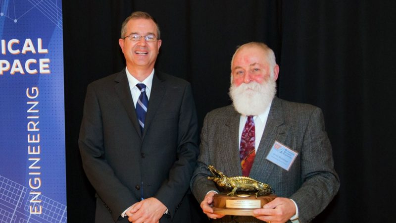 (From left) David Hahn, the chair the Mechanical and Aerospace Engineering Department at the University of Florida, presents the University of Florida's Outstanding Alumnus Award to Arvid Myklebust in 2018. Photo courtesy of the University of Florida.