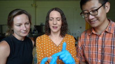 (From left) Leanna House, Anne Staples, and PhD Student Shuyu Zhang inspect a small pump developed in Staples' lab. Photo by Alex Parrish for Virginia Tech.