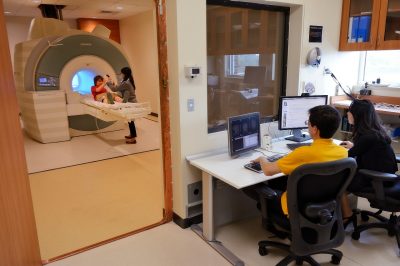 Jungmeen Kim-Spoon and Brooks Casas analyze brain scans of a research participant.