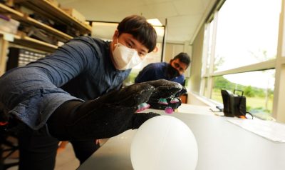 Chanhong Lee and Ravi Tutika test the Octa-Glove in the lab of Michael Bartlett.