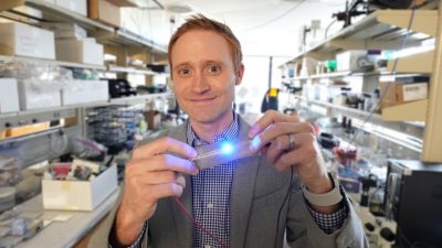Michael Bartlett holds a soft, flexible circuit in his lab. 