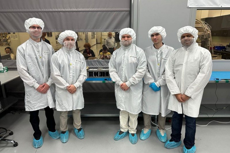 team members around a rocket