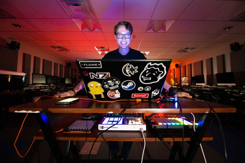 Virginia Tech student making music on his laptop.