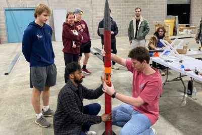 Orbital Launch team assemble the rocket in a workshop space.