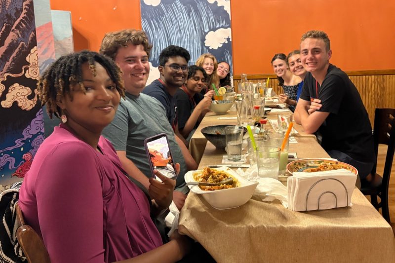 CTech students having a meal around a table.