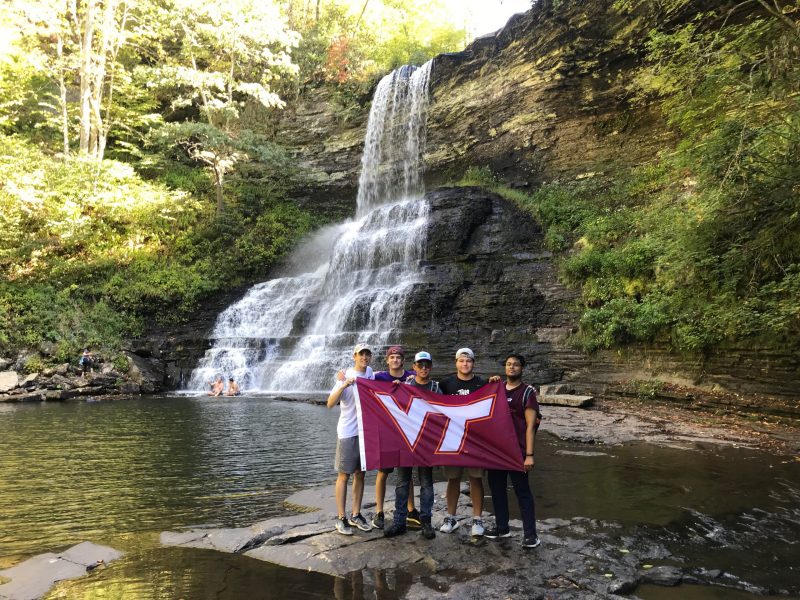 students holding VT flag at The Cascades