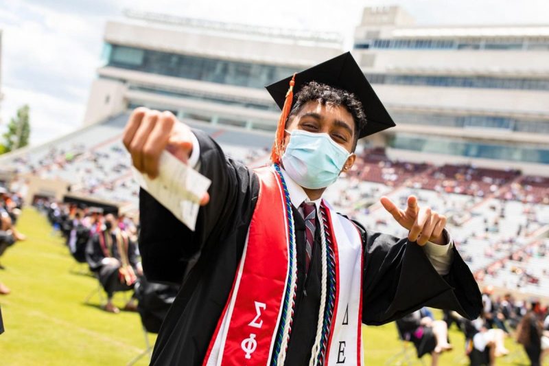 Kirin Anand poses wearing a mask at commencement