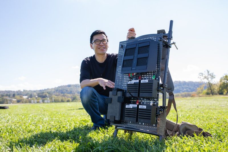 A student with a backpack for tracking drones.