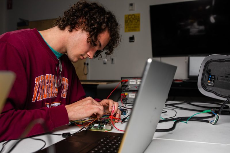 A student working on an electronic circuit.
