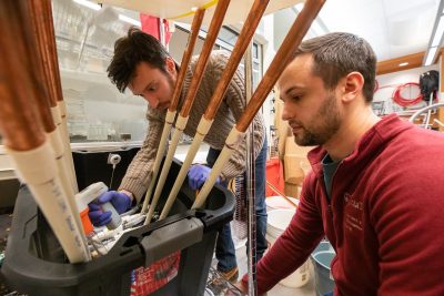 Two graduate students work on a legionella experiment in Amy Prudent's lab