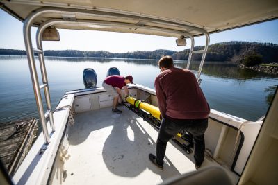 Students loading sub on a boat.