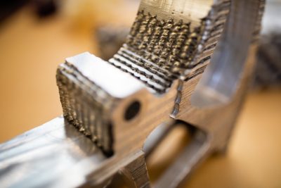 A close up of a 3D printed metal part.