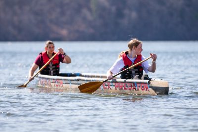 Two team members paddle on the water during the competition.