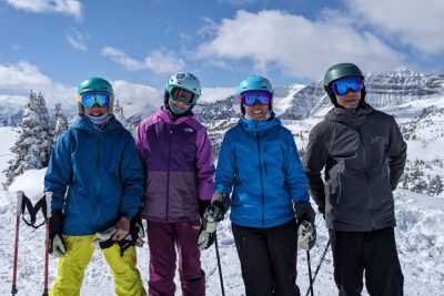 A family photo with Linsey with a snowy mountain backdrop.