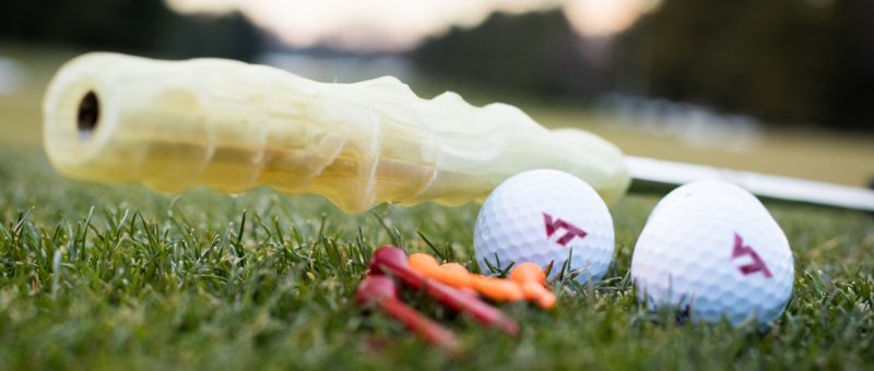 3d-printed-custom-golf-grip 3D printed custom golf grip on a golf course with VT golf balls and tees