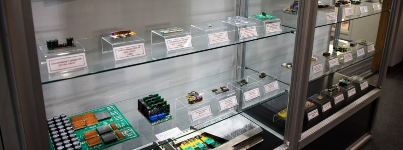 A photo of a display case filled with small electronic devices, chips, and boards.
