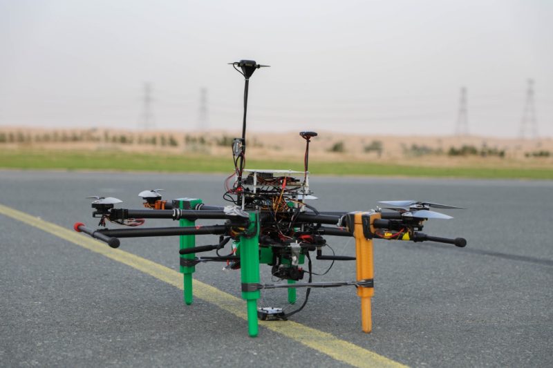 A close up of a drone, with a desert horizon in the background.