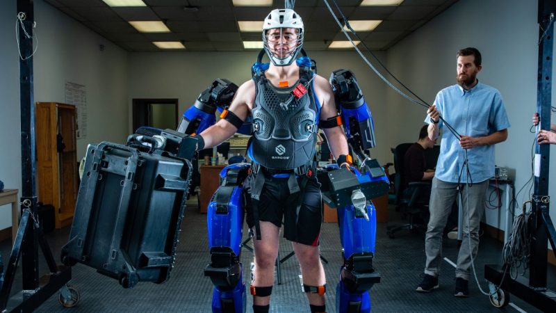 A student in a lab wearing an exoskeleton.